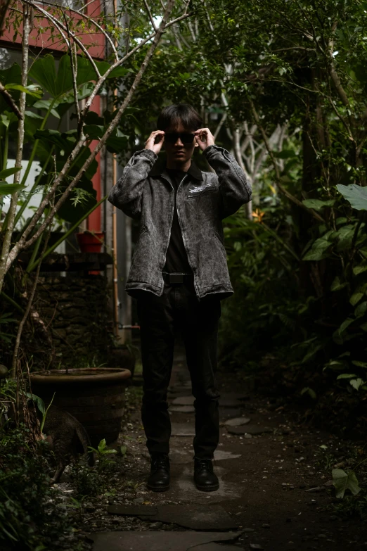 the man is walking down a path in a wooded area