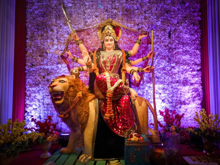 the statue of the indian god ganesh sits atop the lion