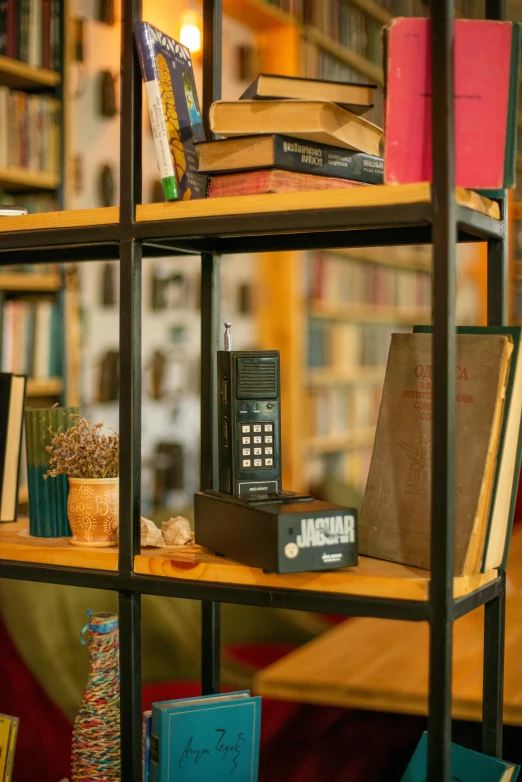 a row of books on top of a wooden shelf