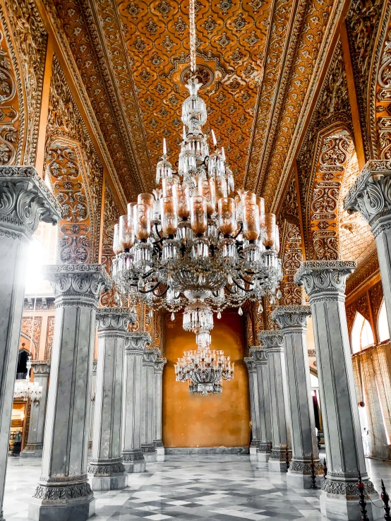 an ornate chandelier hangs from the ceiling inside a building