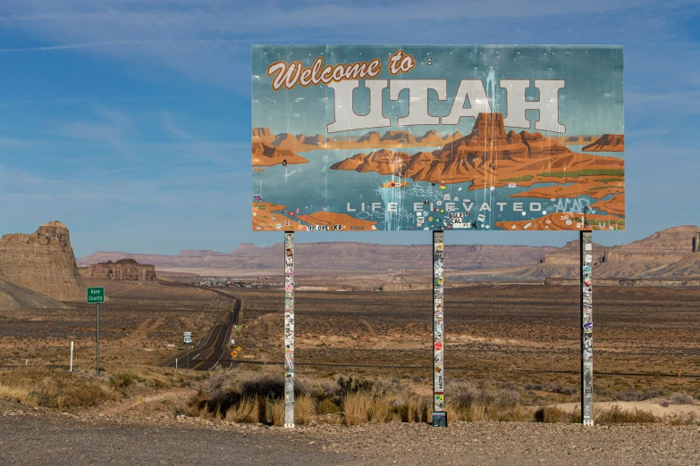 a big sign by a road in the desert