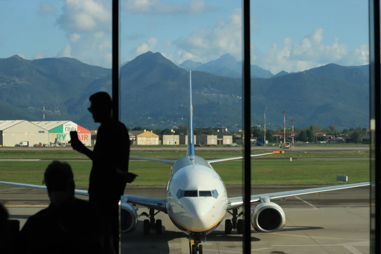 an airplane sitting on the tarmac with its wheels down