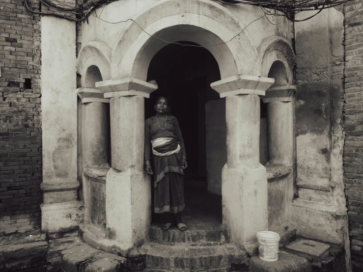 a person stands in a doorway with a basket