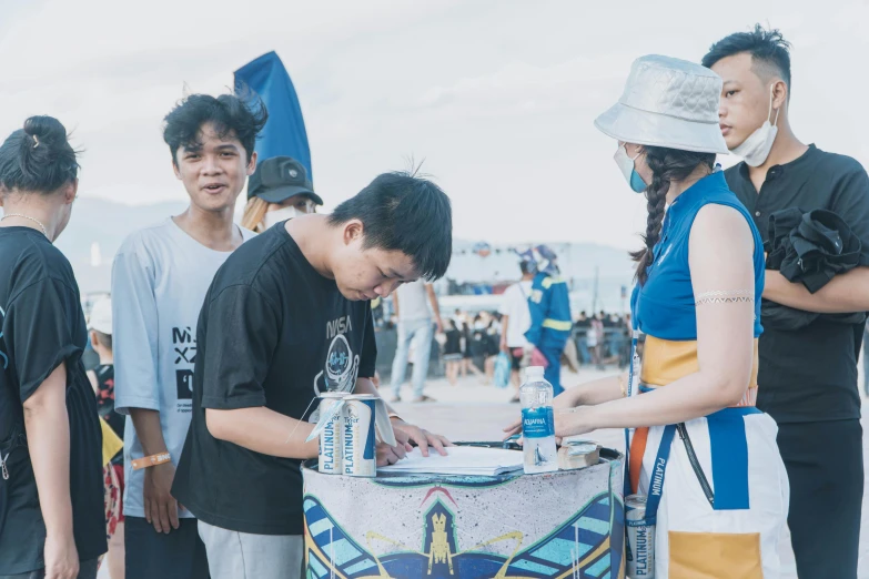 two young people are drawing on a table