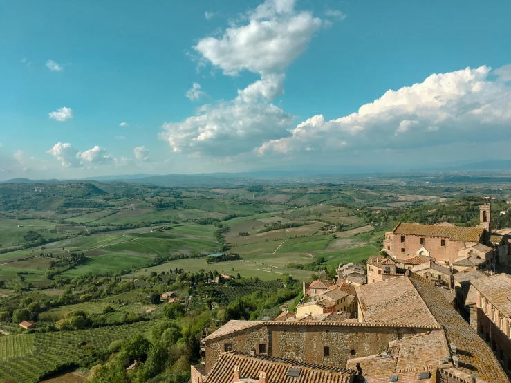 the view of an old village nestled within the hills