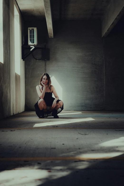 a woman kneeling on the floor in a room