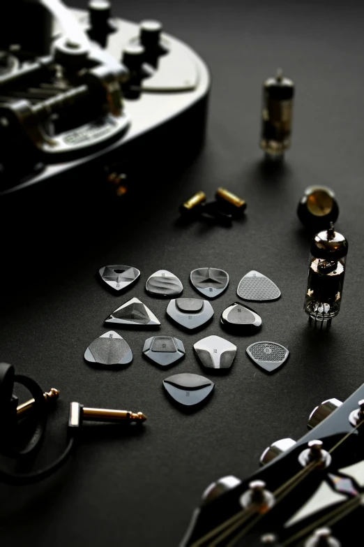 several different kinds of music instruments laying on a black table