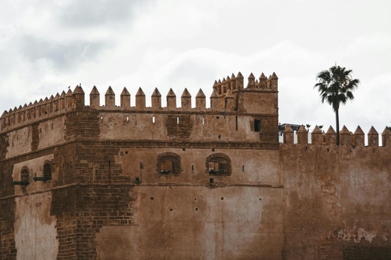 a large brick castle wall with an open door