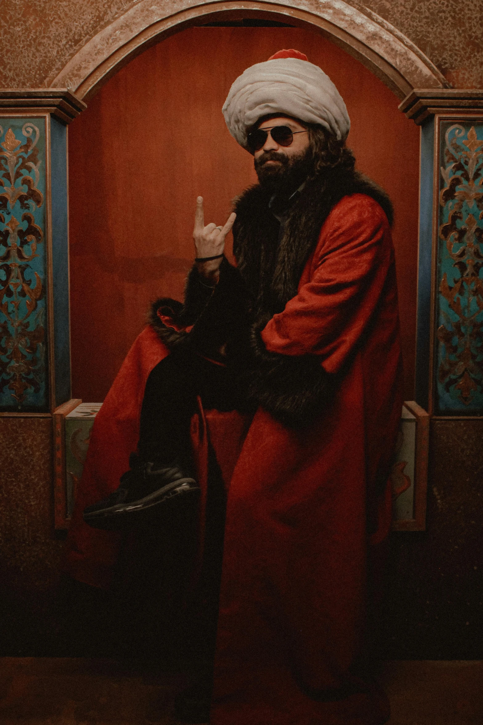 a man with a turban sitting in a chair