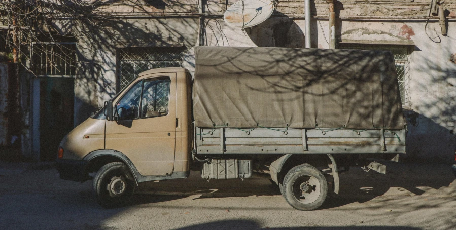 an old truck is parked on the street