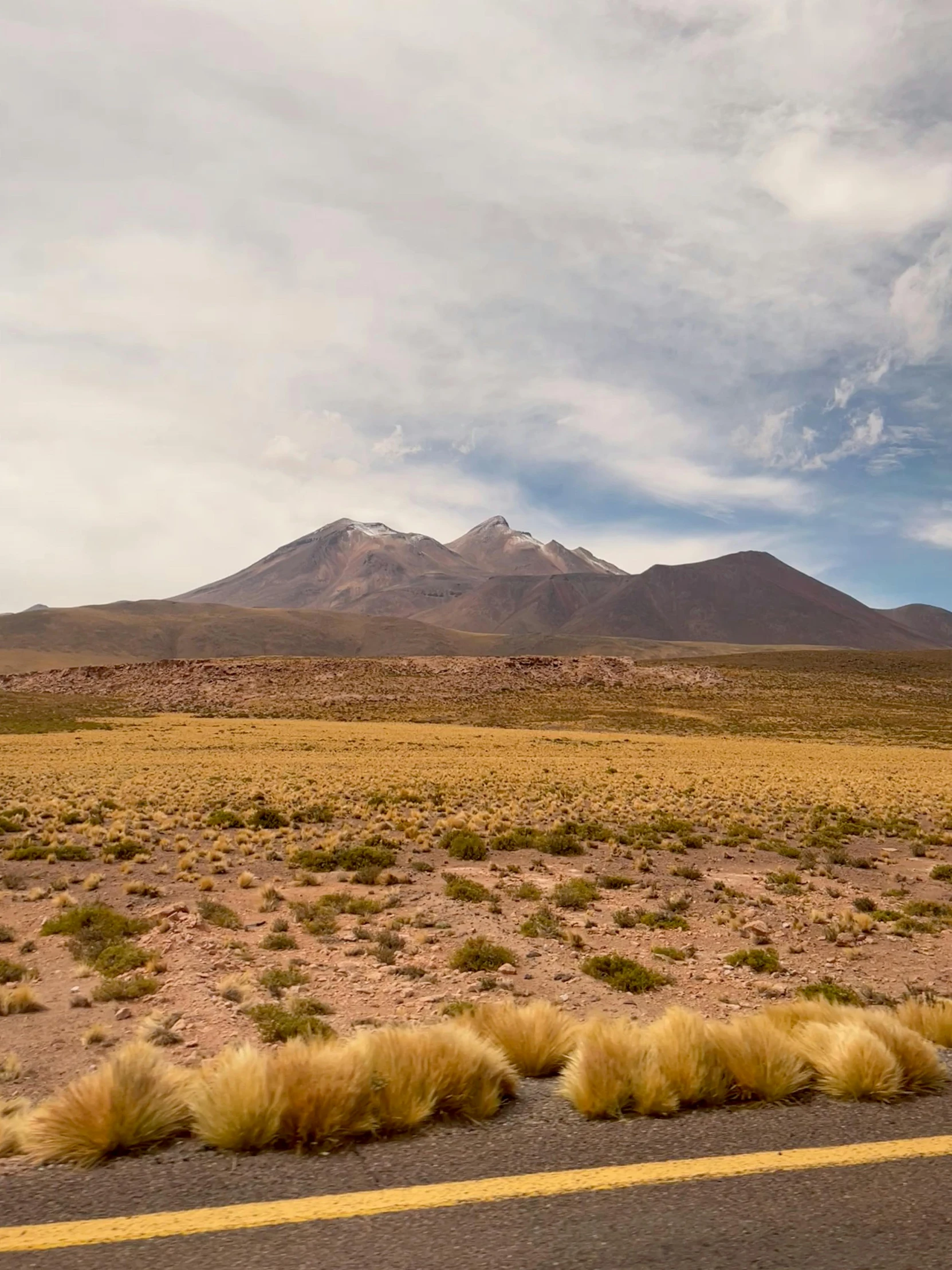 a dry road with a mountain in the distance