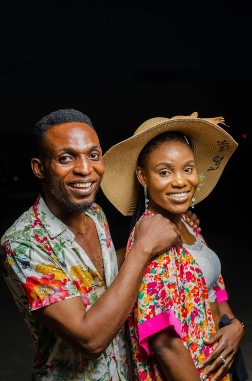 a black man and a woman with a large hat