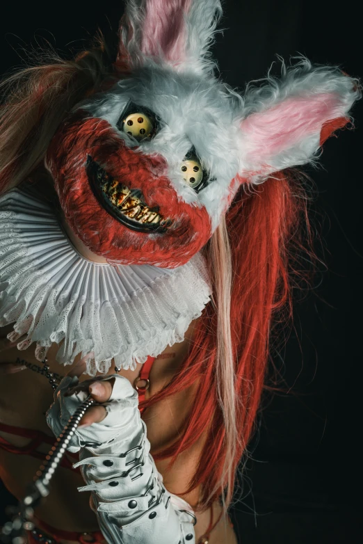 a woman dressed in costume and a mask on her face