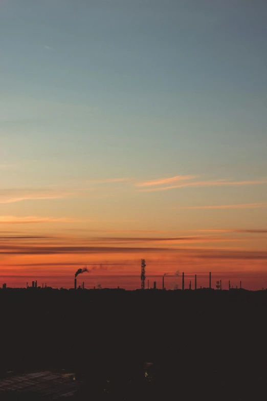 a distant airplane with a sunset in the background