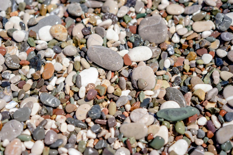 several different stones and pebbles on a beach