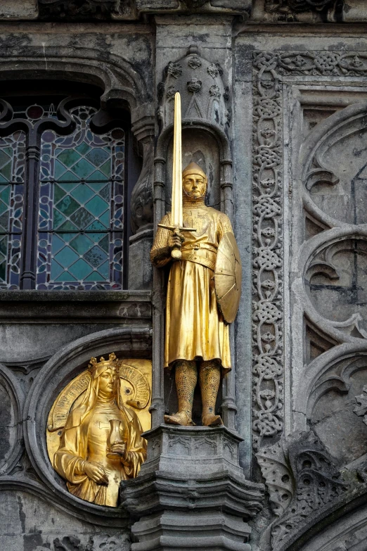 a large statue is next to a golden object