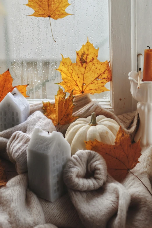 an assortment of candles, towels and maple leaves