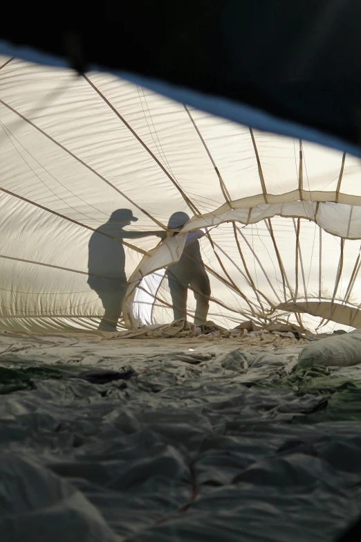 two people with large nets on the ground