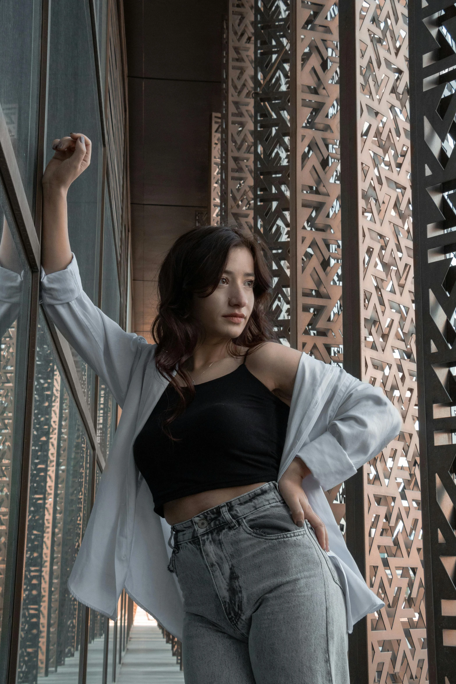 a young lady poses with her hands on her hips