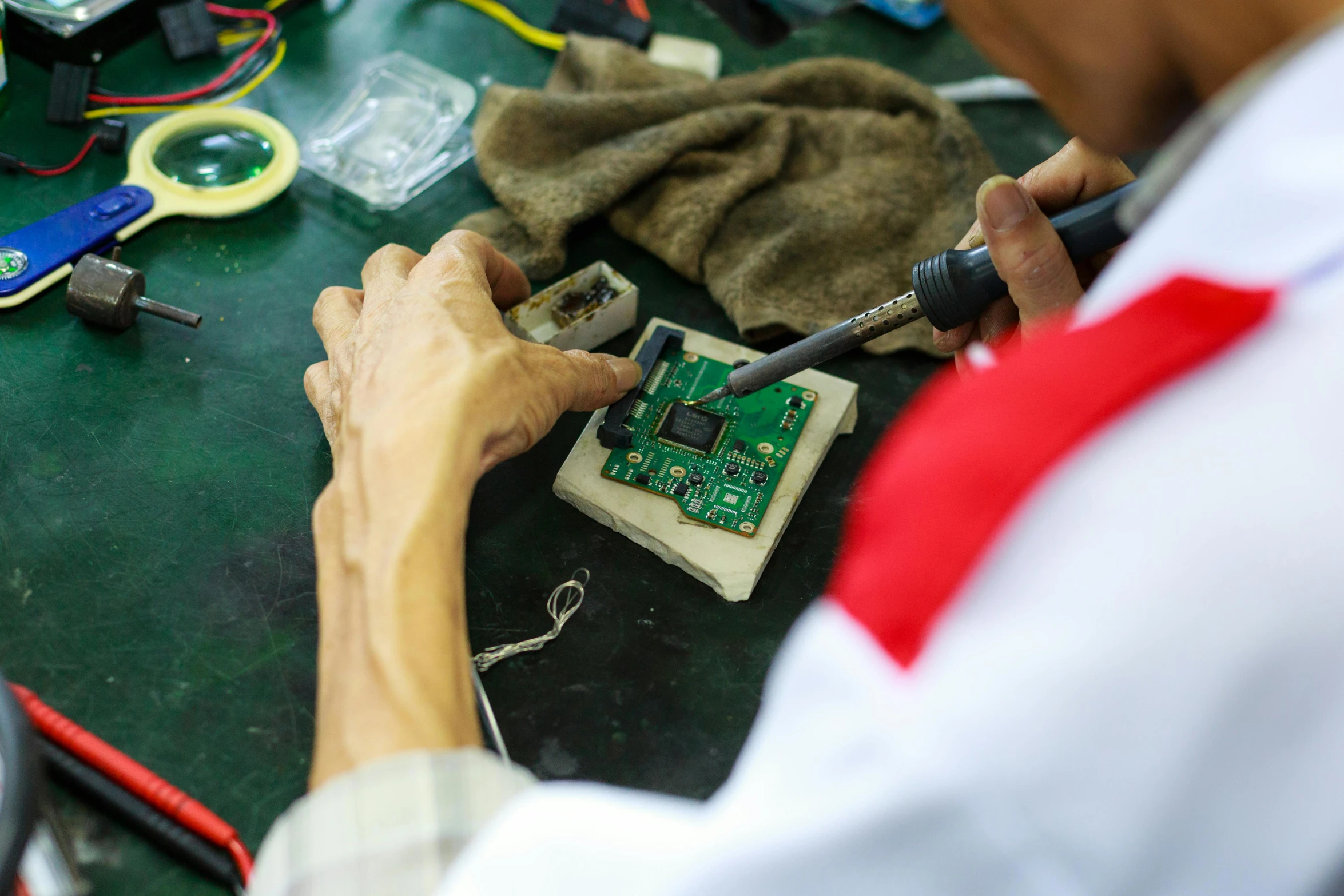 someone working on some electronics at their home