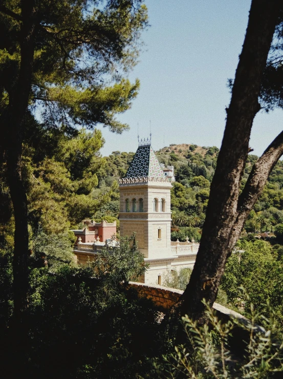 a tower in the distance surrounded by trees