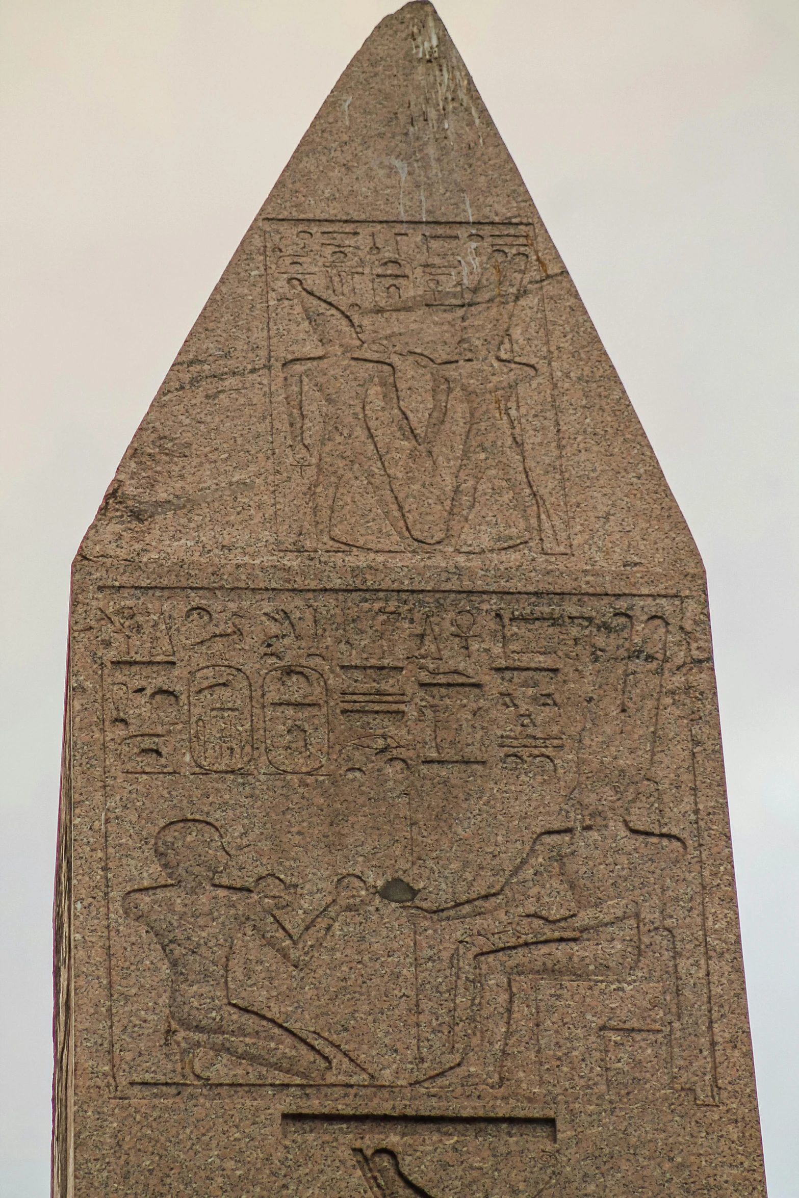 a tall egyptian styled monument with carvings in the corner