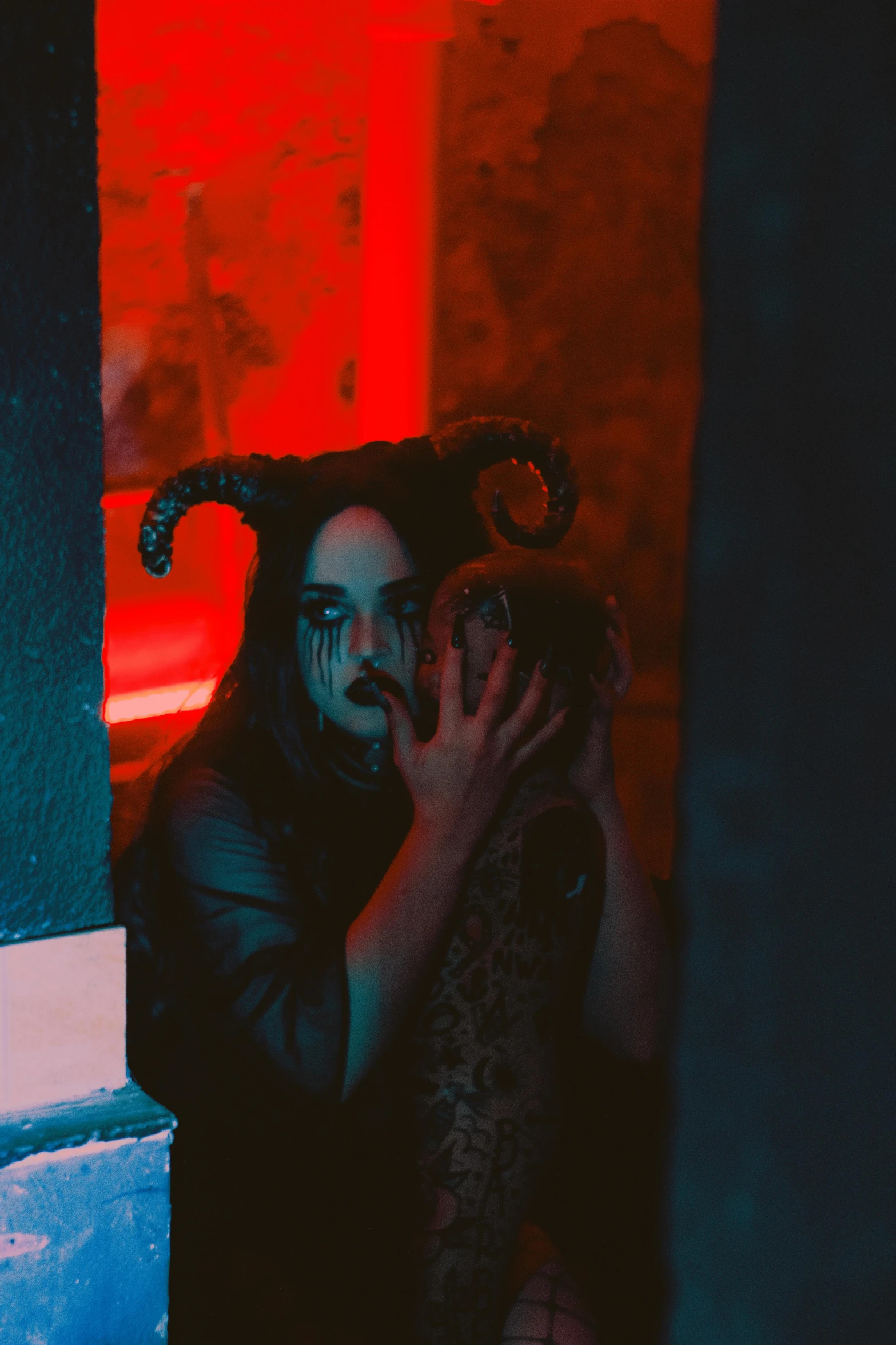 a man wearing horned hair and an evil looking face in the doorway of a building