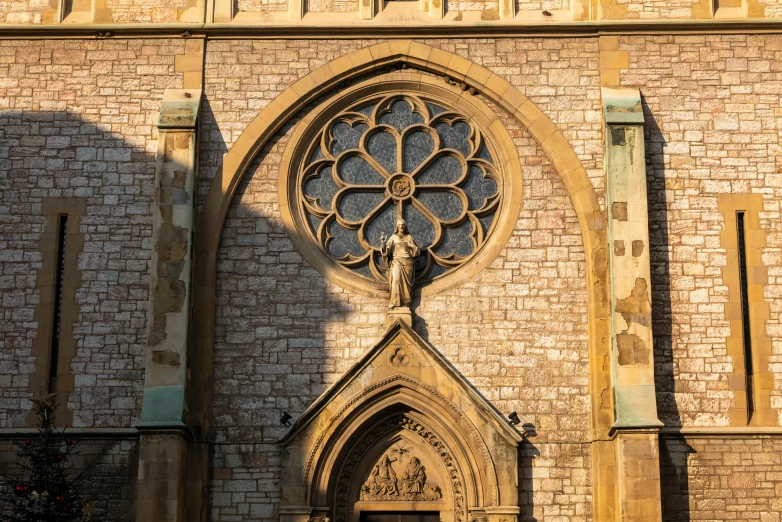 the building is made of stone, with the cross