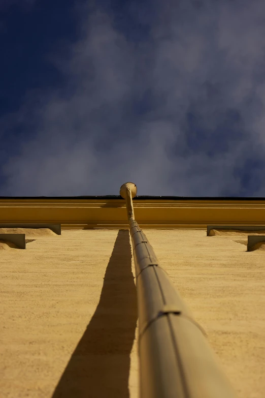 an empty street pipe going up the side of a building