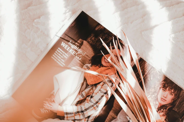 an open magazine laying on top of a bed