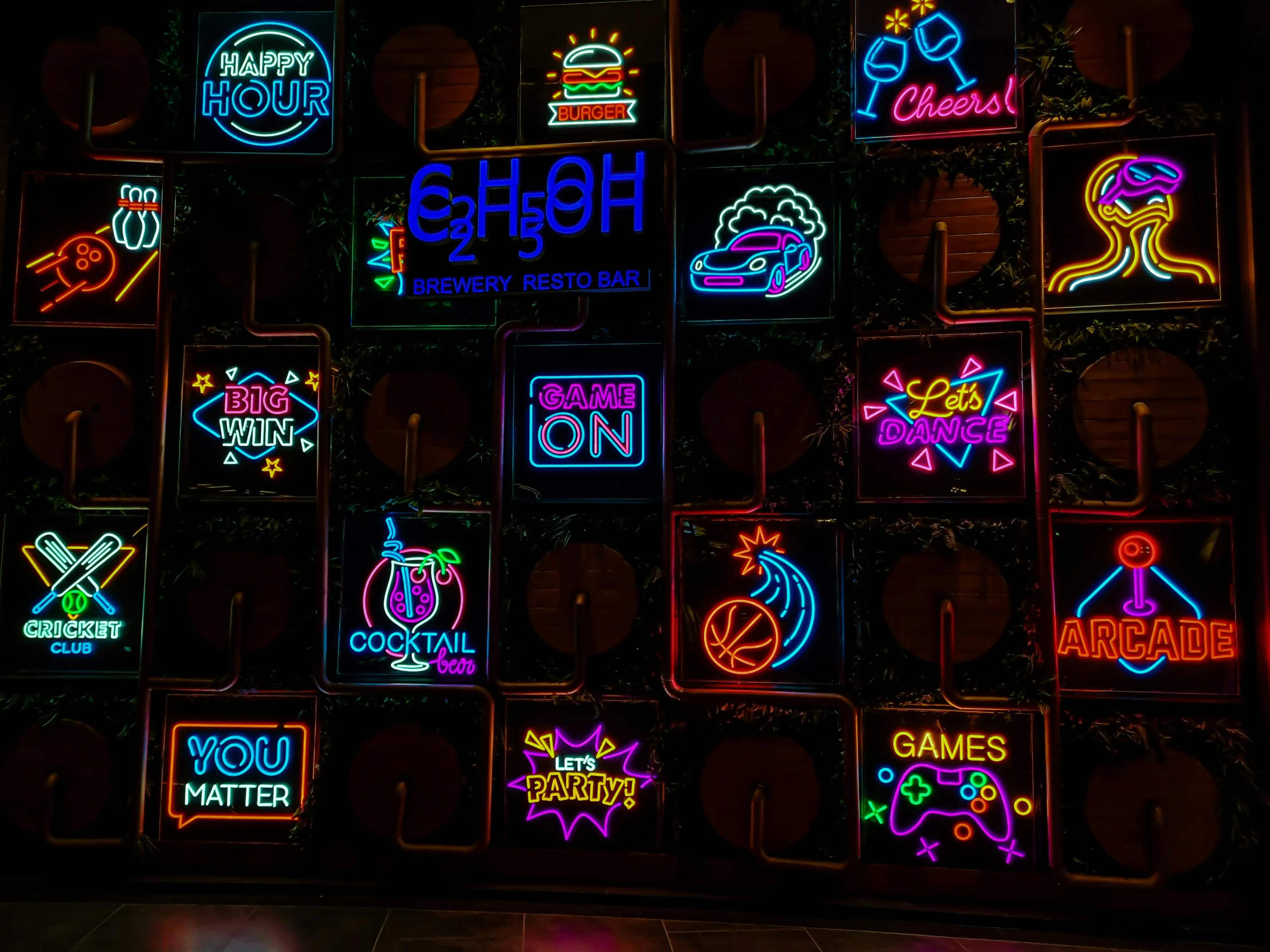 many different neon signs displayed on the walls