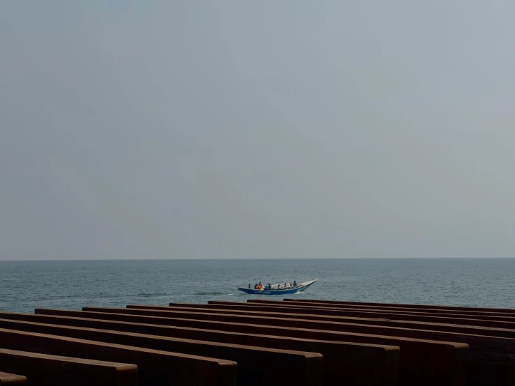 a small fishing boat sits idle in the water