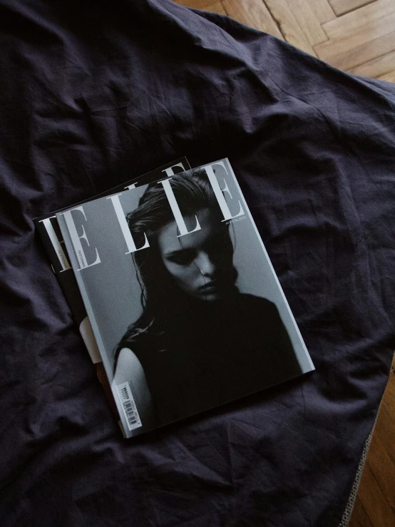 the magazine lies on top of the black shirt