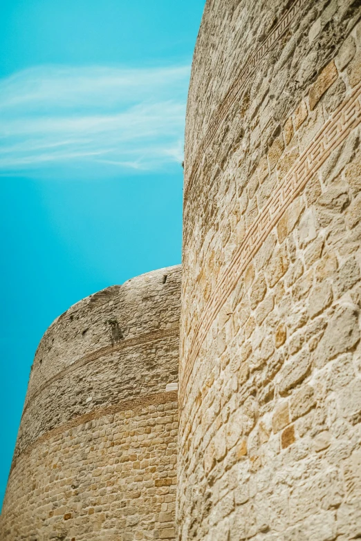 a po looking up the side of a very large rock wall