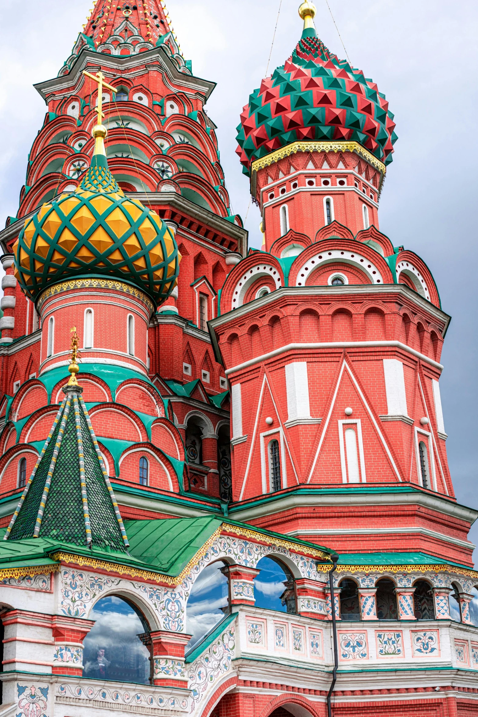 an intricate red church that has domes on it