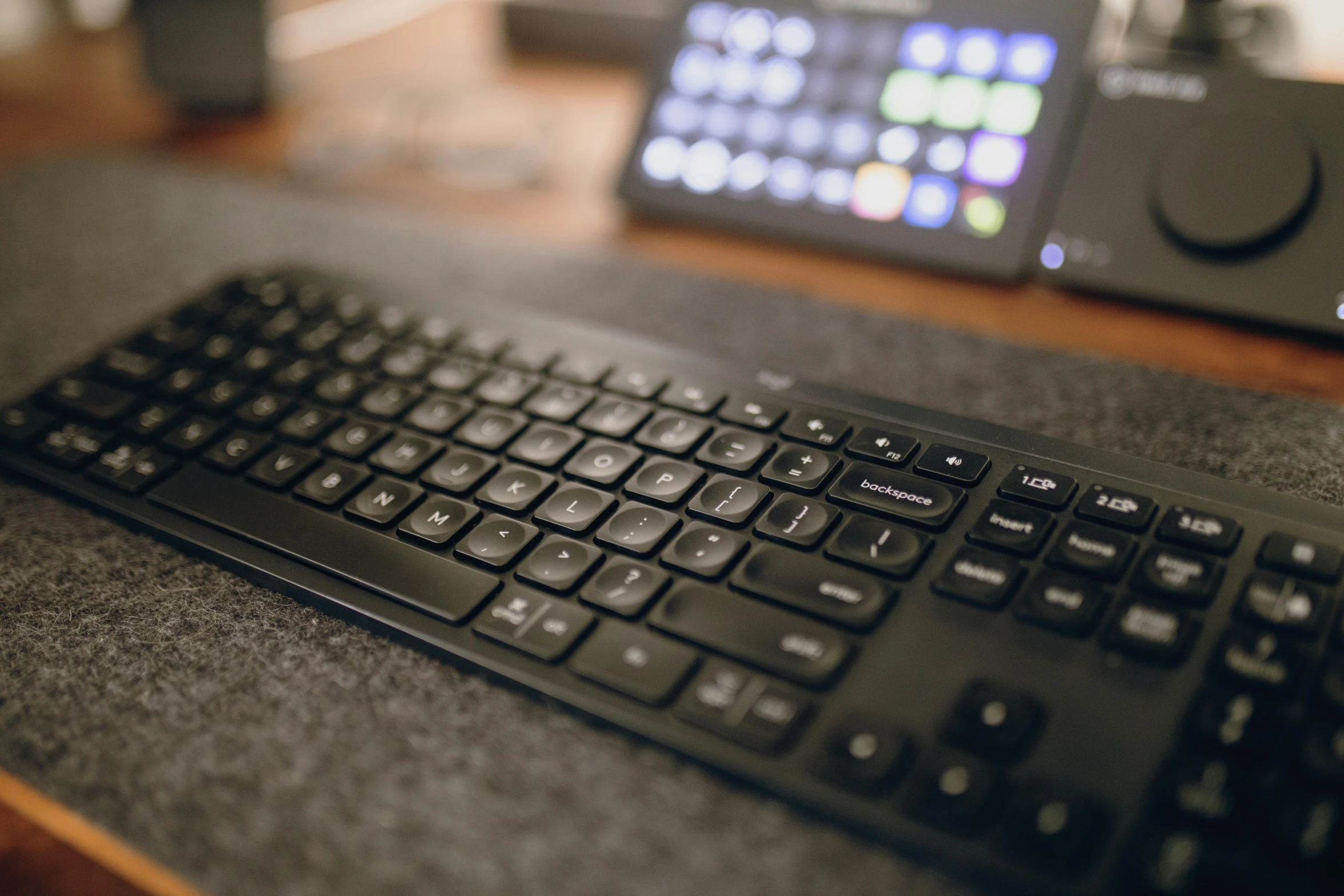 the keyboard sits beside the black mouse on the table