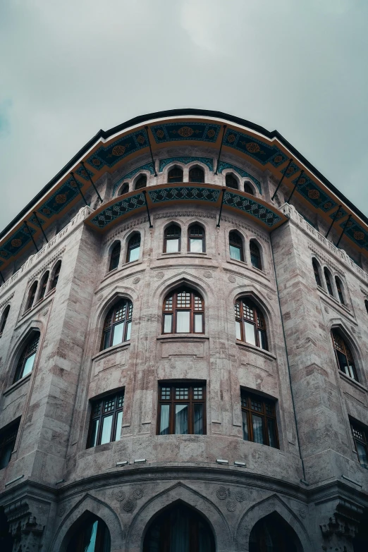 a building with multiple windows has ornate carvings on the wall