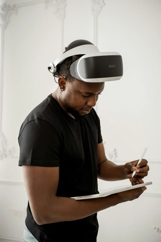 a person holding a paper while wearing a head mounted device