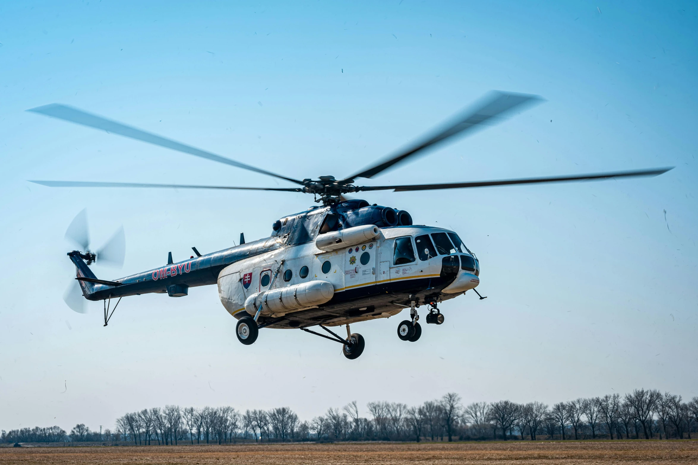 a helicopter flies in the sky on a clear day