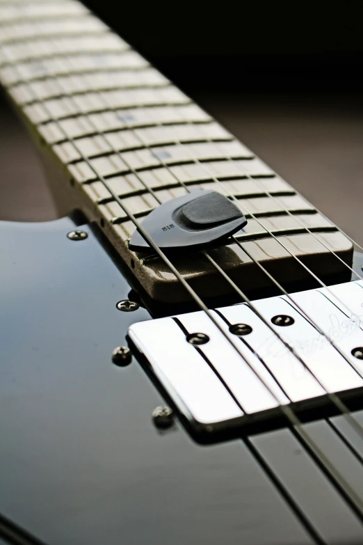 the bridge and pickup  on a black guitar