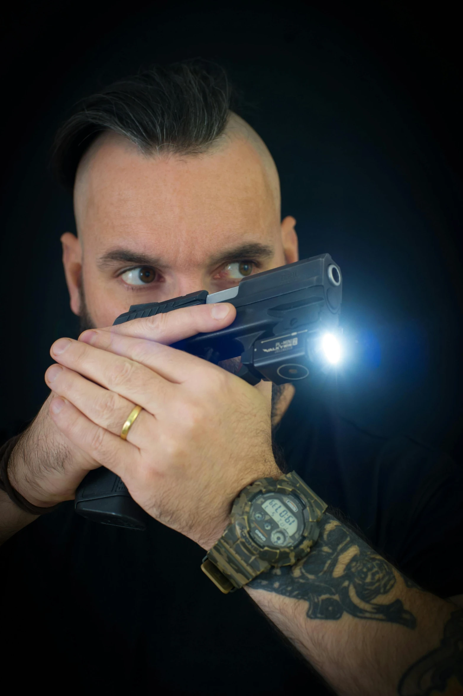 a man holding a small camera in front of his face