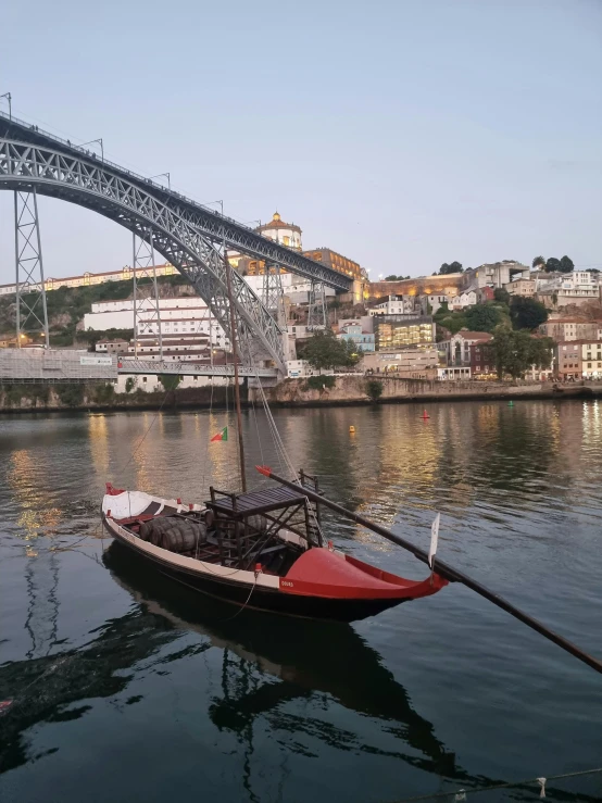 a small boat on the water and some buildings in the background