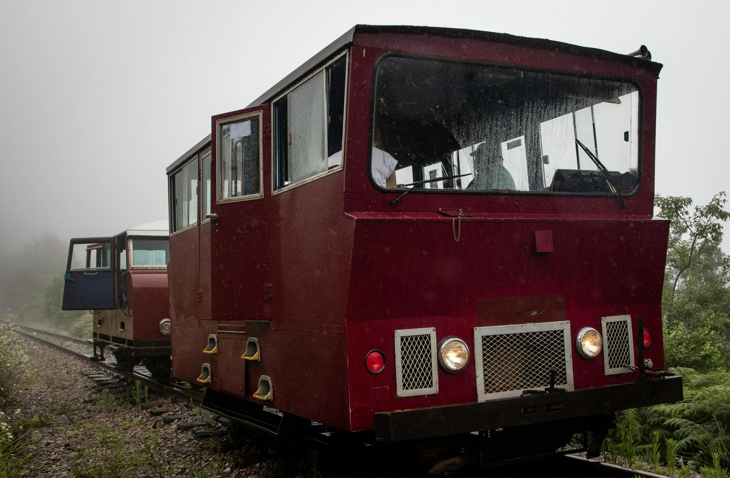 the old trolley car is on the train tracks