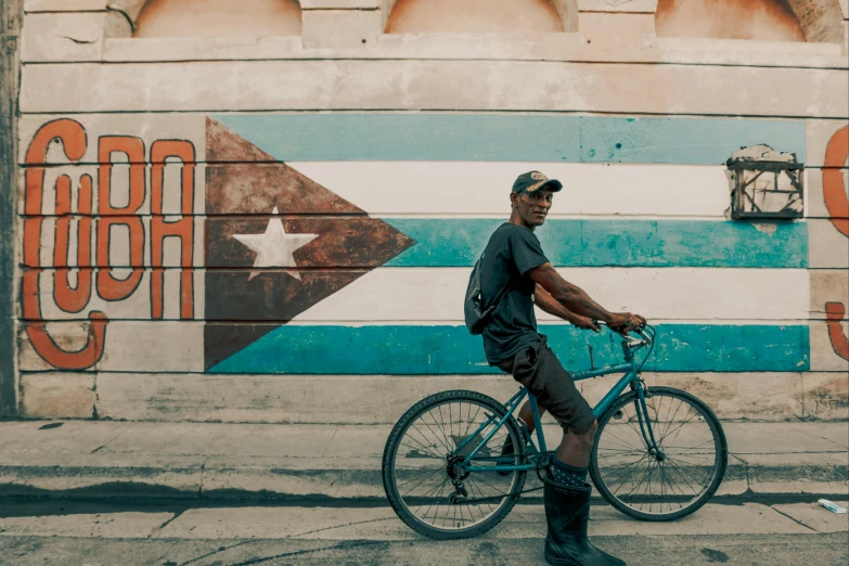 a man is riding his bicycle down the street