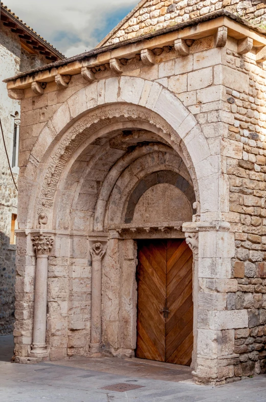 the door is brown and open on the stone structure