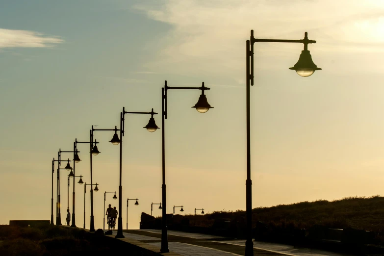 the light poles have been set along the path and are lit up by lamps