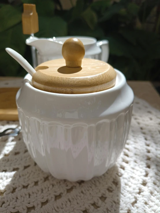 a pair of salt and pepper pots on a knit tablecloth