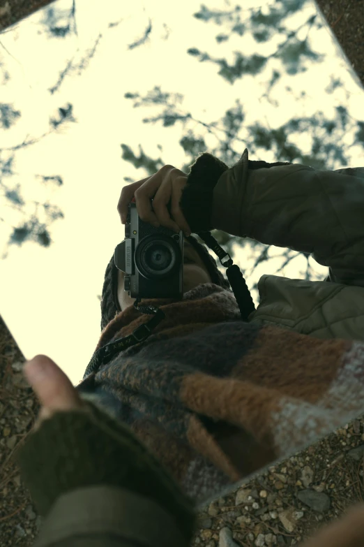 a person holding a camera over their face