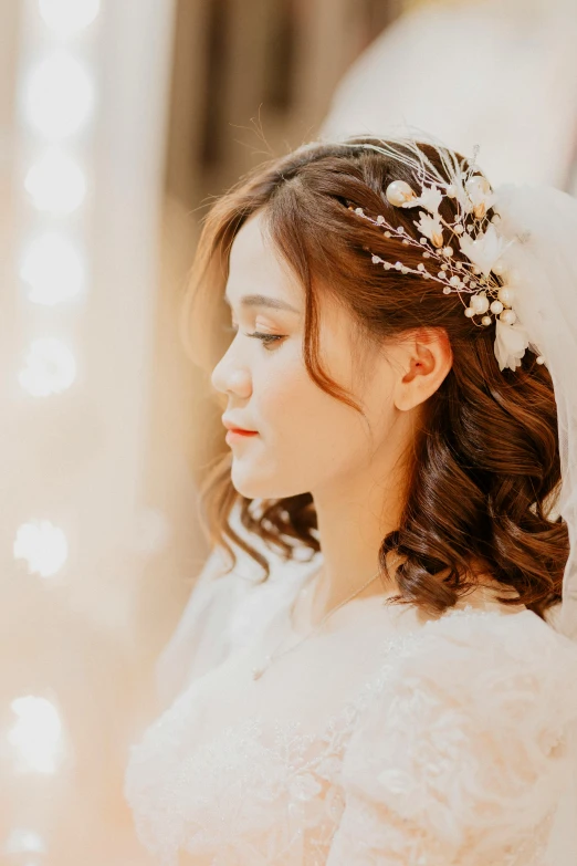 this is a woman wearing a wedding dress and headpiece