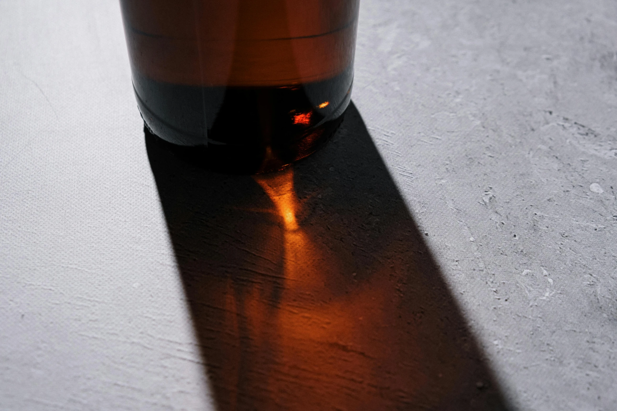 a brown glass is shown sitting on a counter